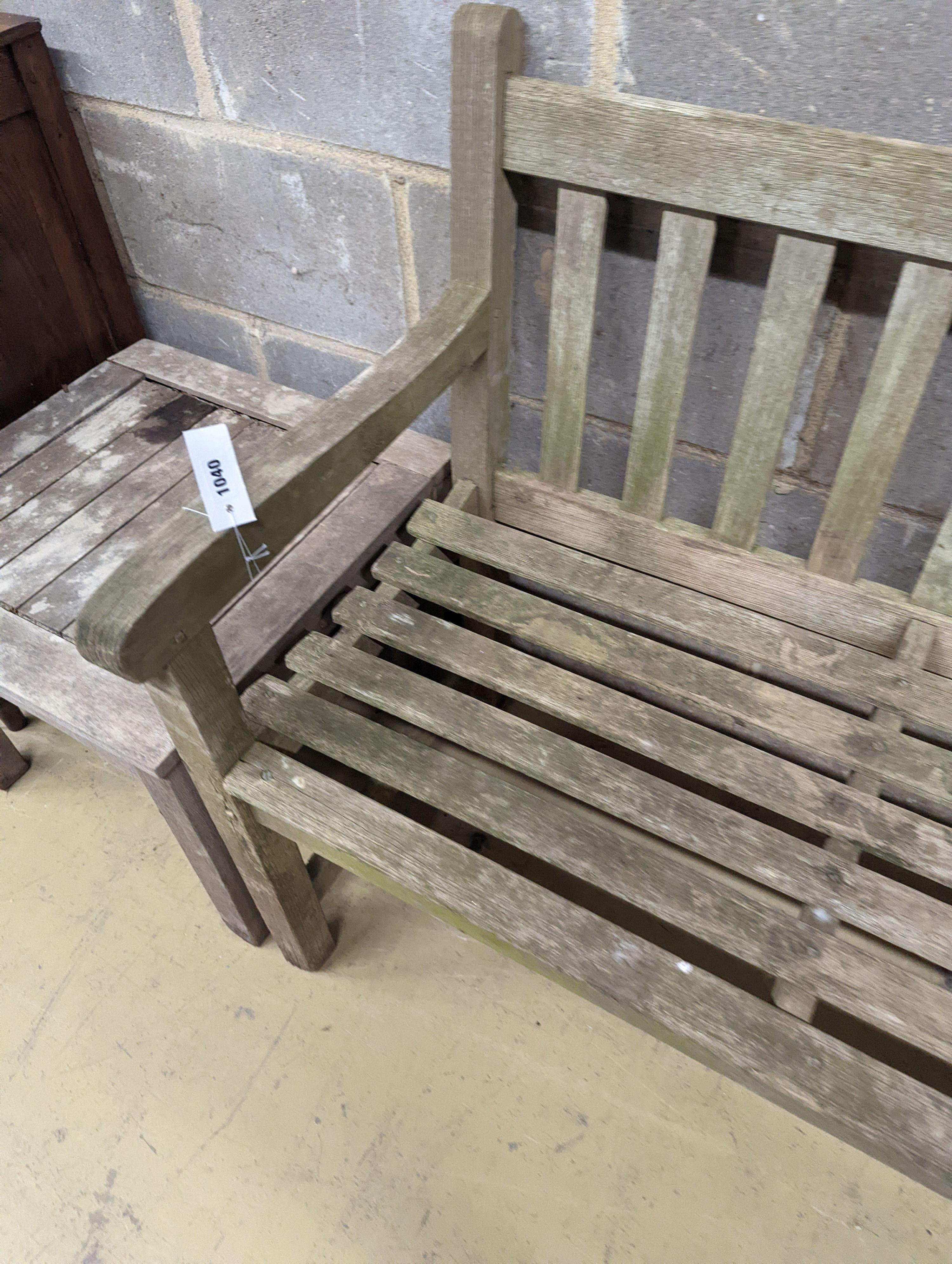 A weathered teak garden bench, length 153cm, depth 50cm, height 79cm and a low square table